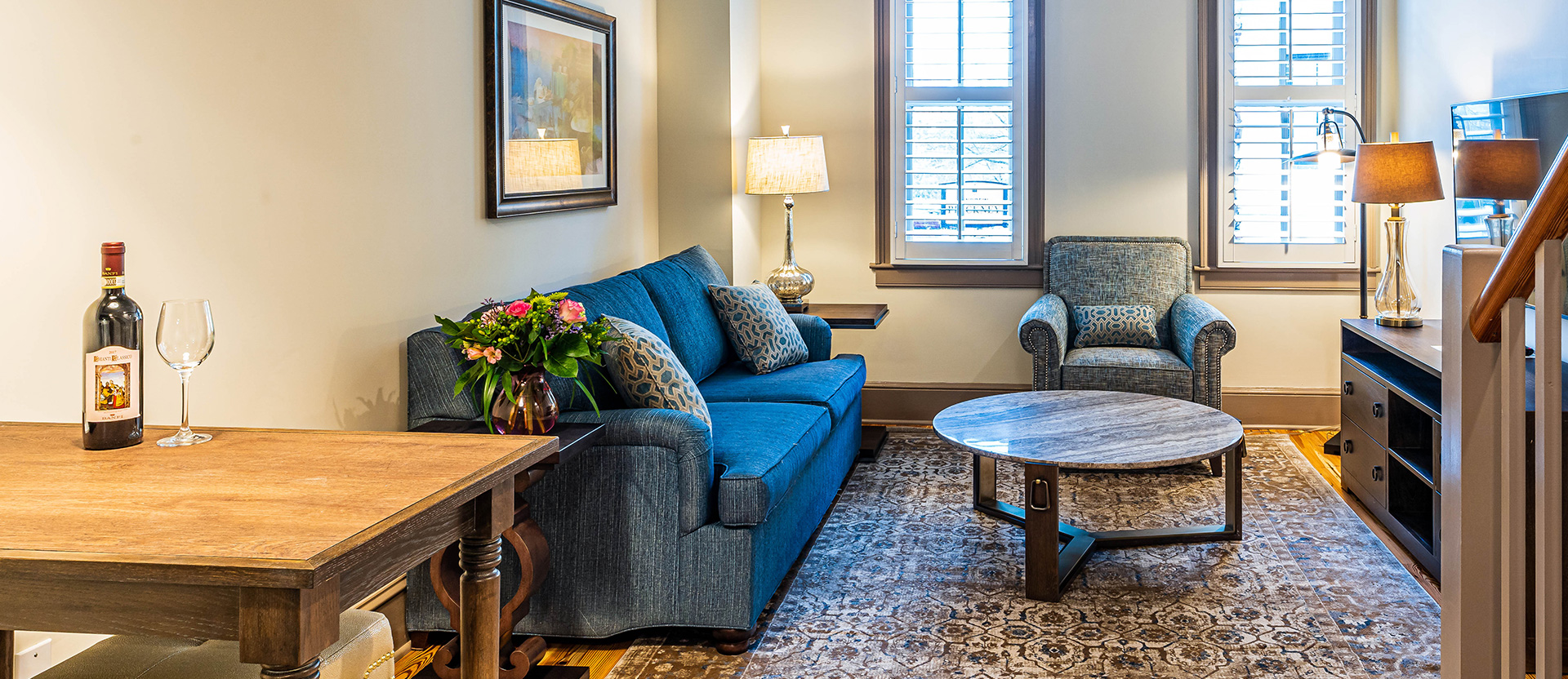 living room with sofas and a table with a glass of wine