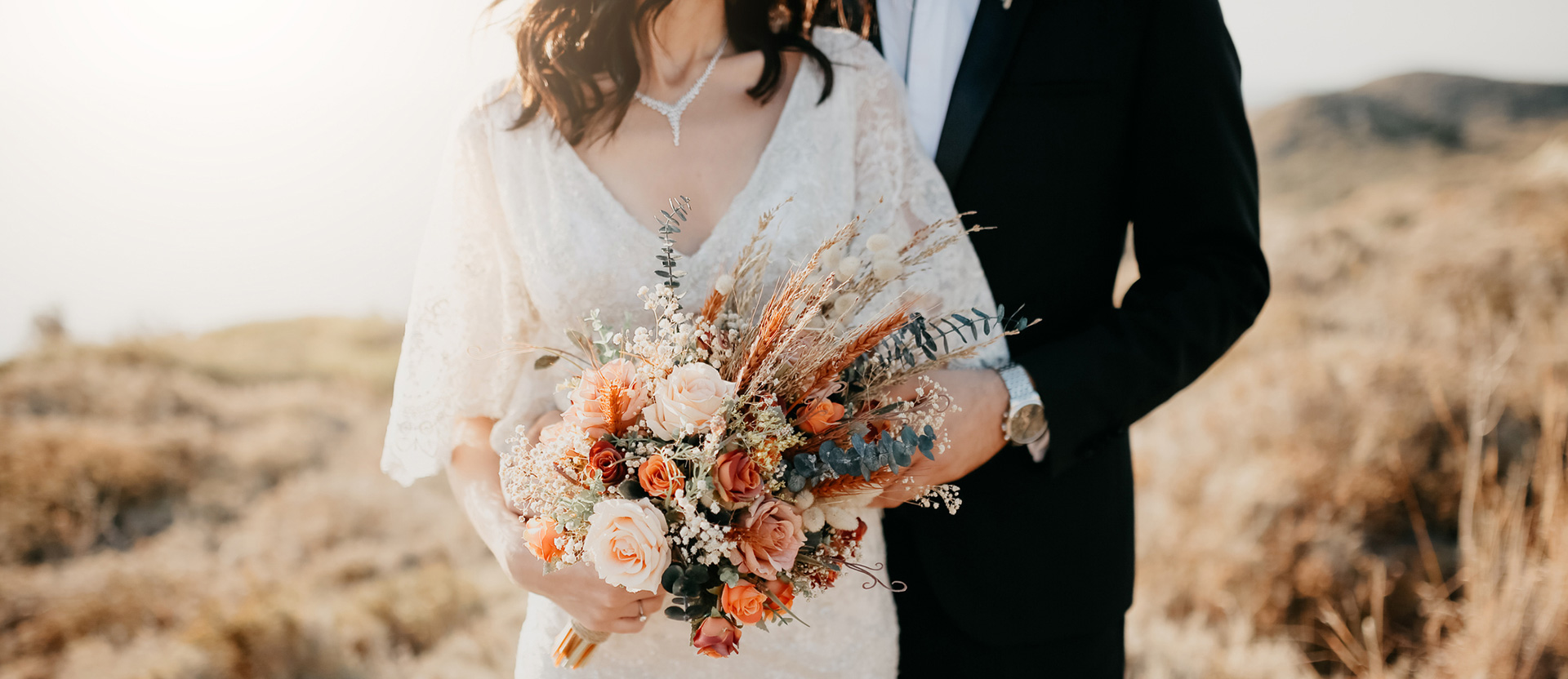 a bride holding her bucket next to the groom