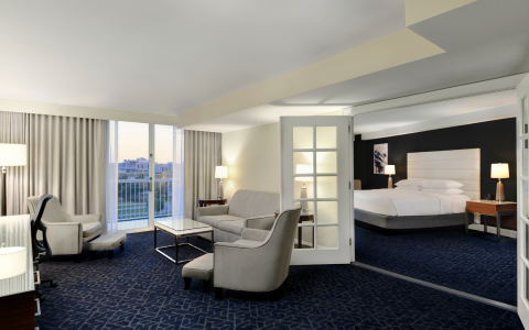 king room suite with a white bed and living room