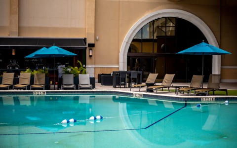 a pool with chairs and umbrellas