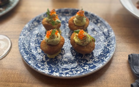 a plate of food on a wood table