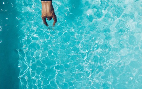 a man diving into the pool
