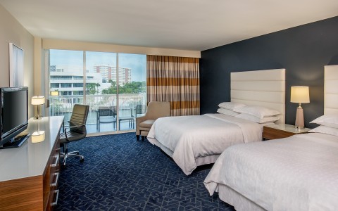 a hotel room with two beds and a chair