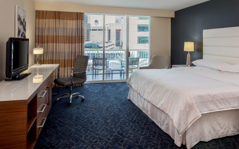 a room with a bed and a desk and a chair