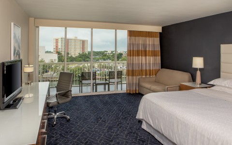 a room with a bed and a desk and a chair