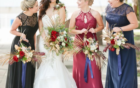 bride with her bridesmaids and their flower bouquets
