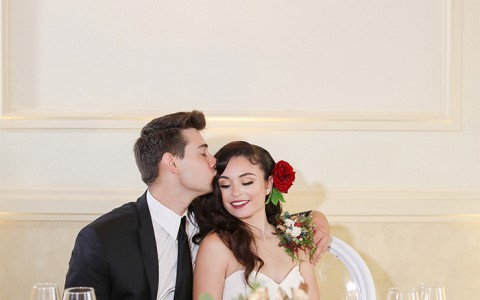 bride and groom in each others arms at the table