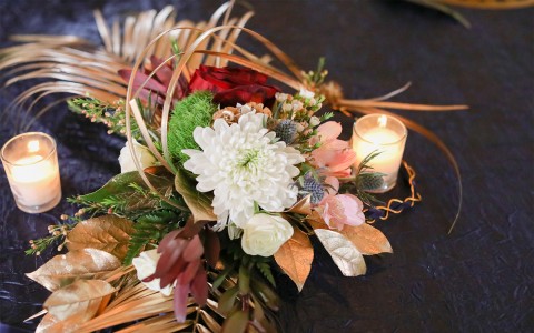 the floral arrangement with candles for a wedding event