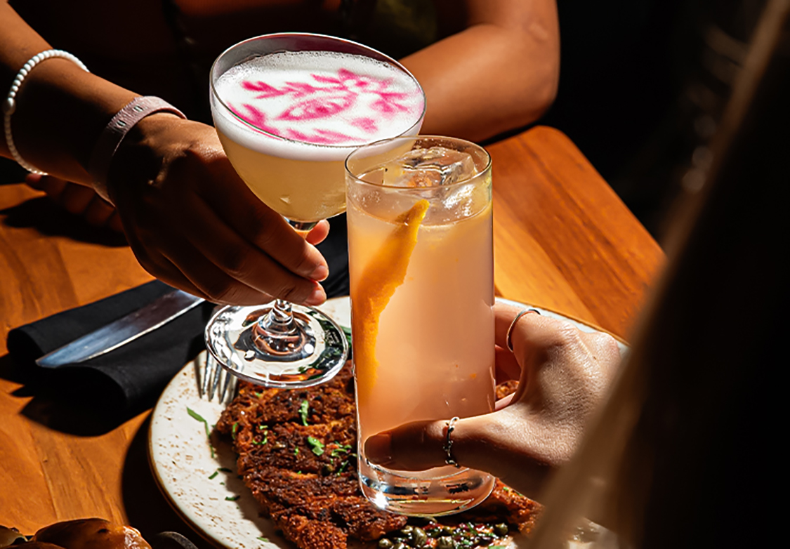 a pair of hands holding drinks