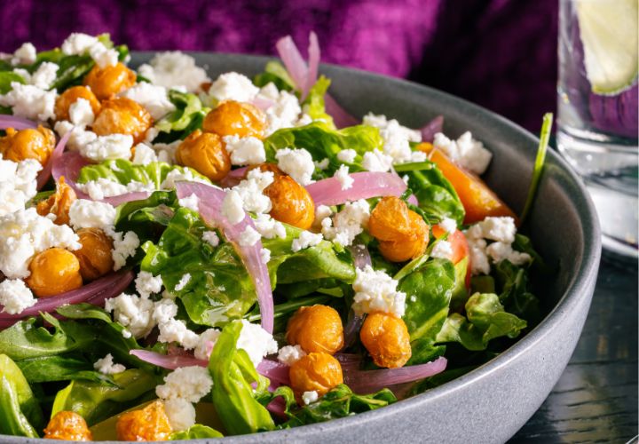 a bowl of salad with chickpeas and feta cheese
