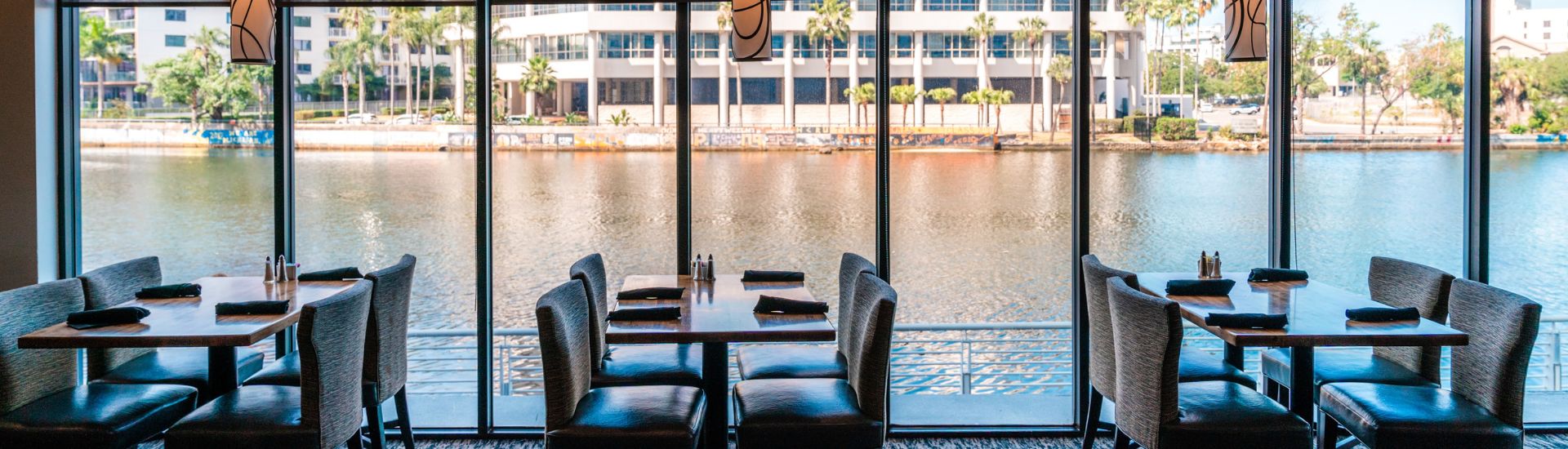 a table with chairs and a view of a body of water