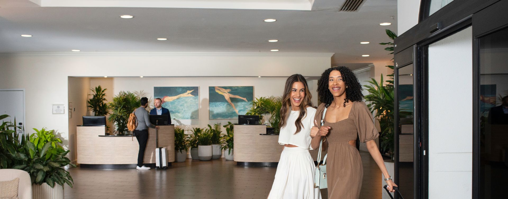 two women standing in a lobby