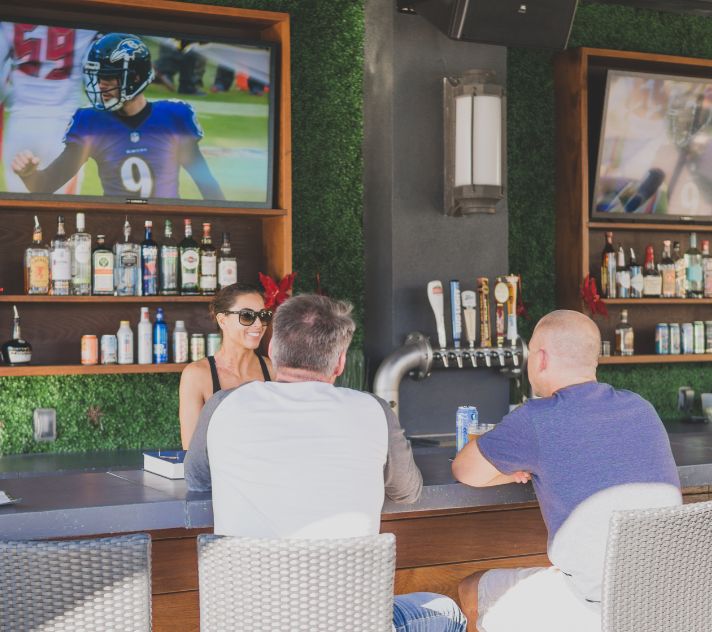 a group of people sitting at a bar