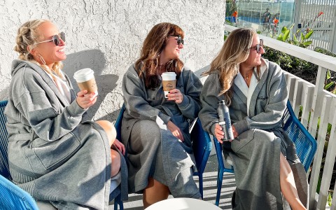 a group of women sitting on a patio