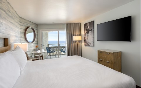 a bedroom with a large bed and a television