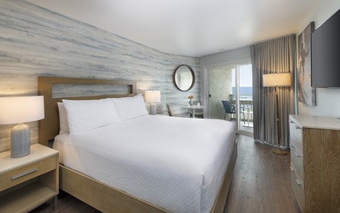 a bedroom with a bed and a glass door