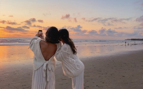 two women standing on a beach