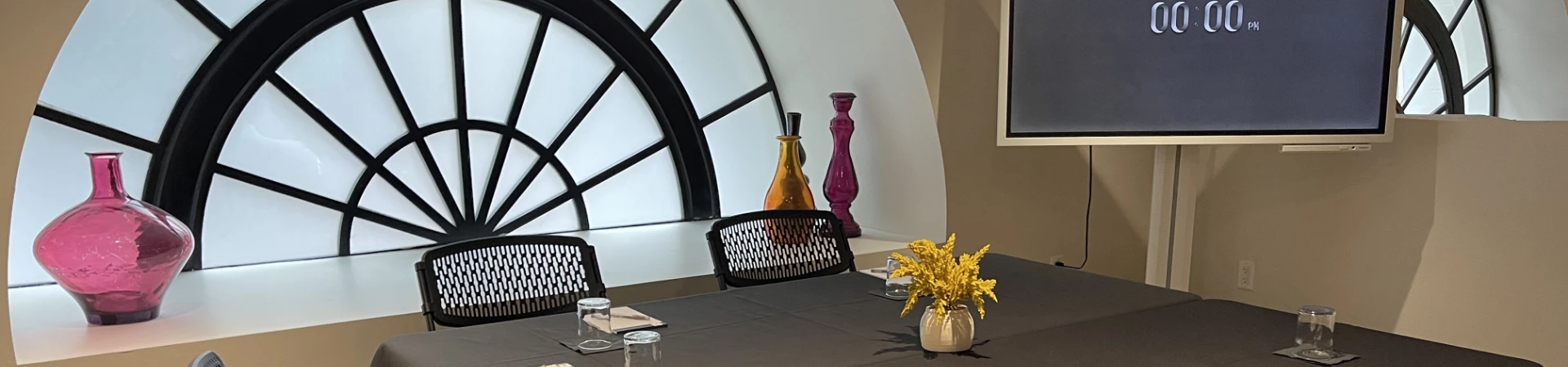 a table with a vase of flowers and vase of flowers