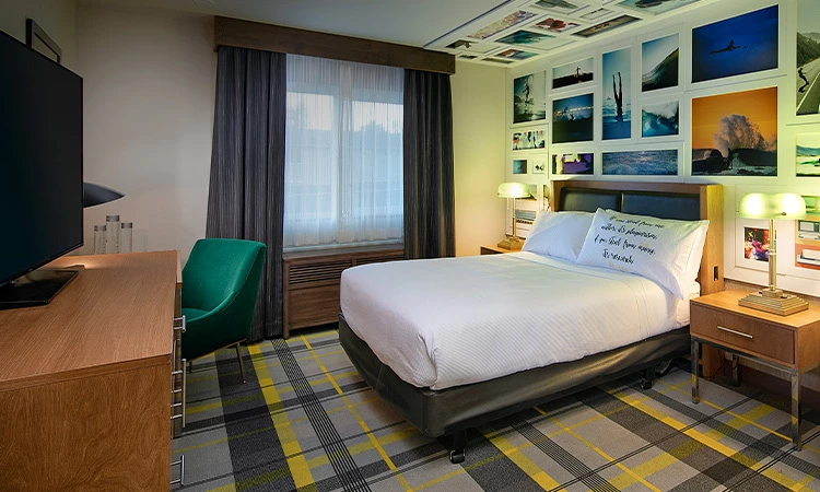 single bed with pillows and images on the walls