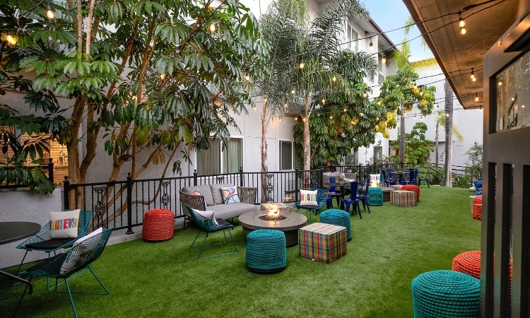 a patio area with a fire pit and chairs