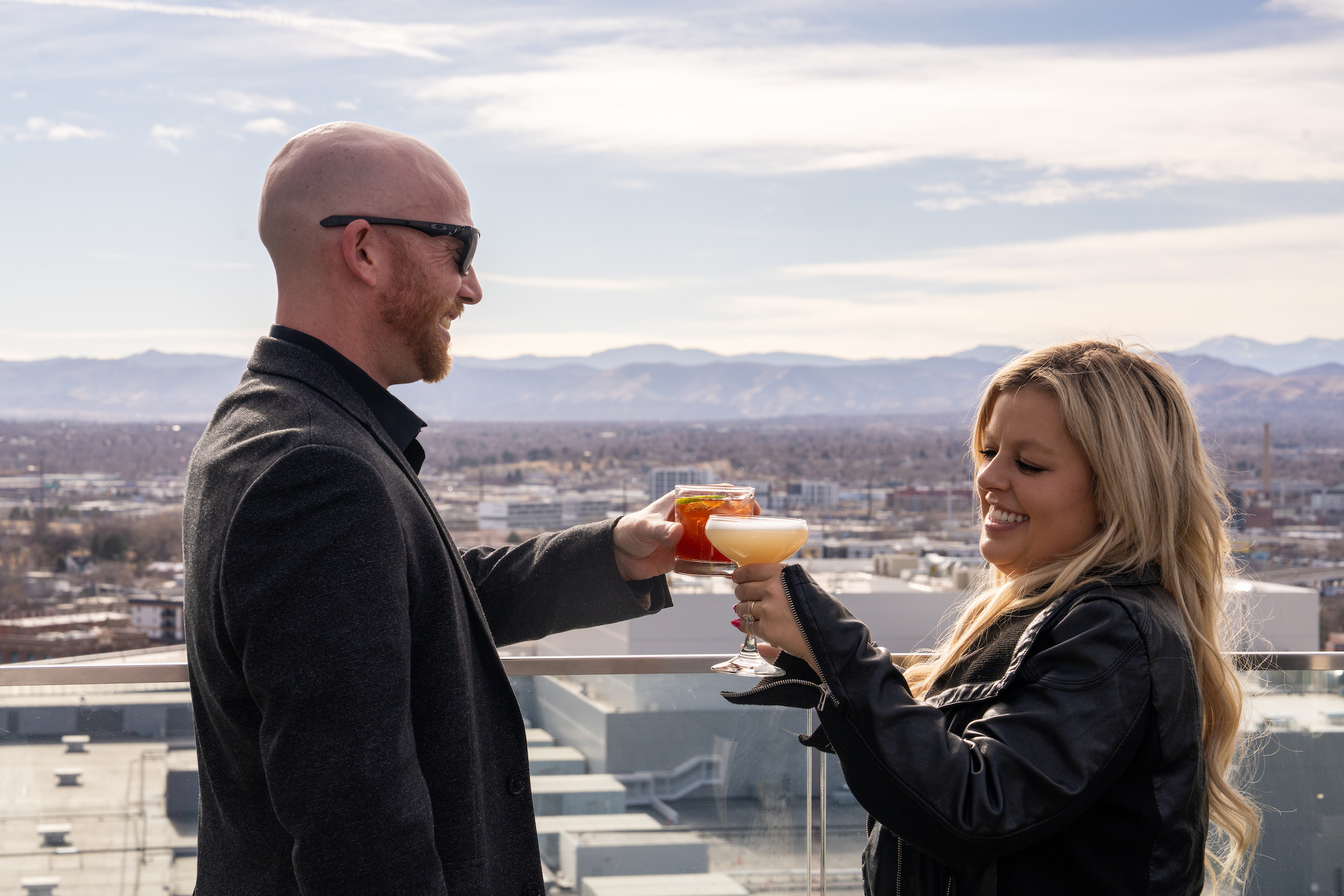 a man and woman holding drinks
