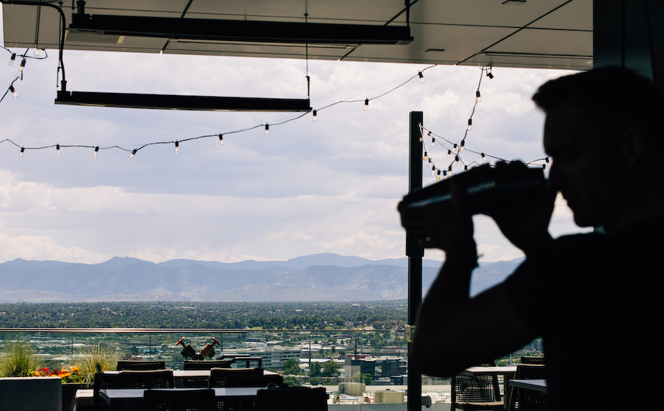 a person holding a gun in front of a city