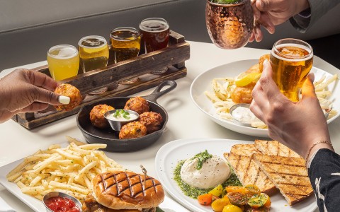 a group of people sitting at a table with food