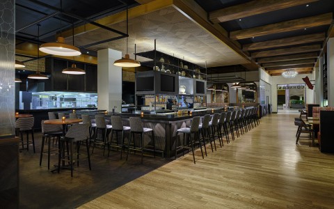 a restaurant with a long bar and chairs