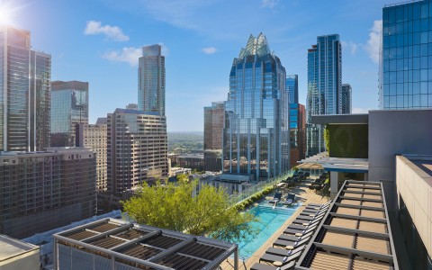 a rooftop pool with a swimming pool in a city