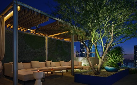a patio with a couch and a tree