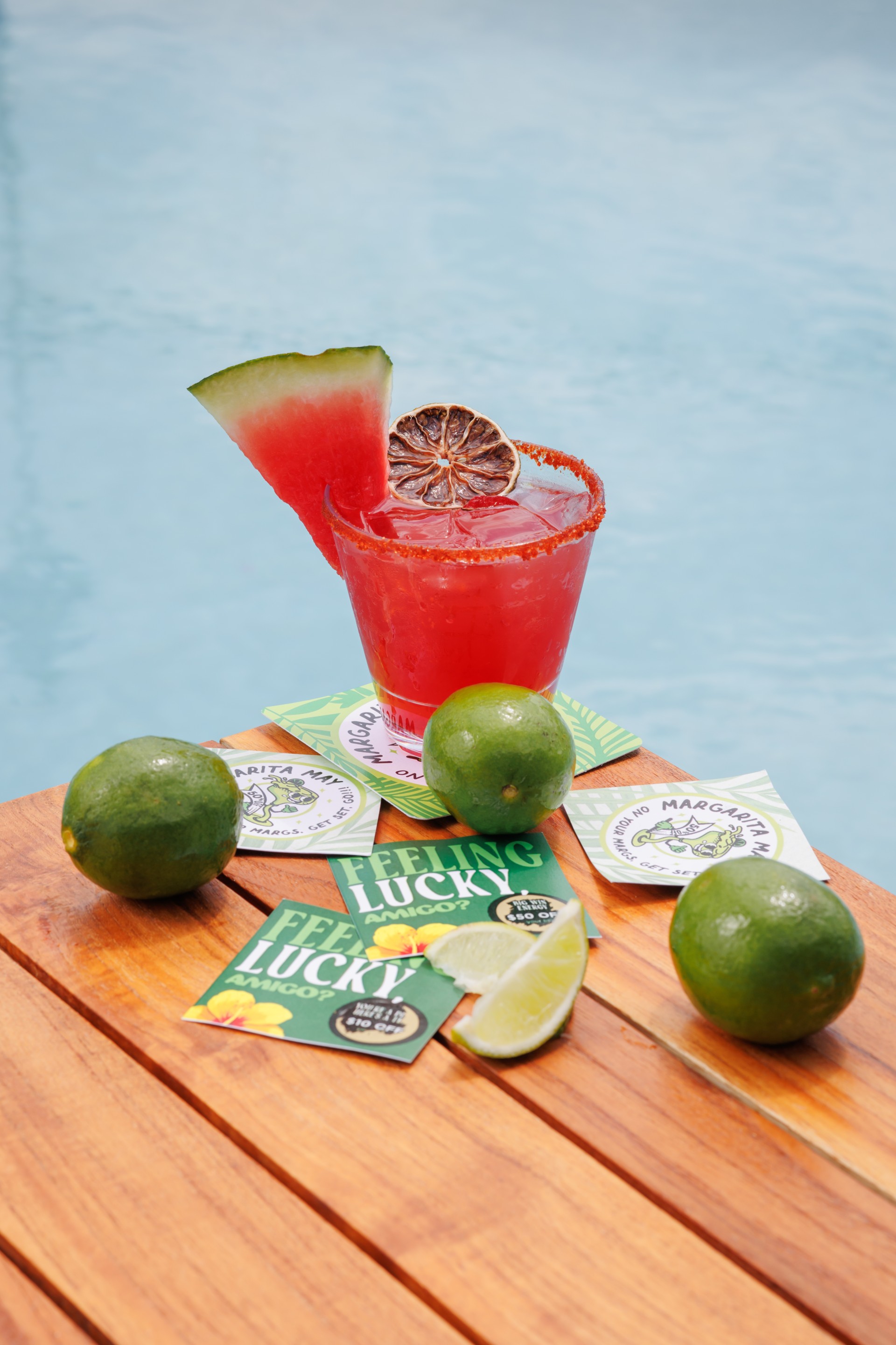 a drink and limes on a table