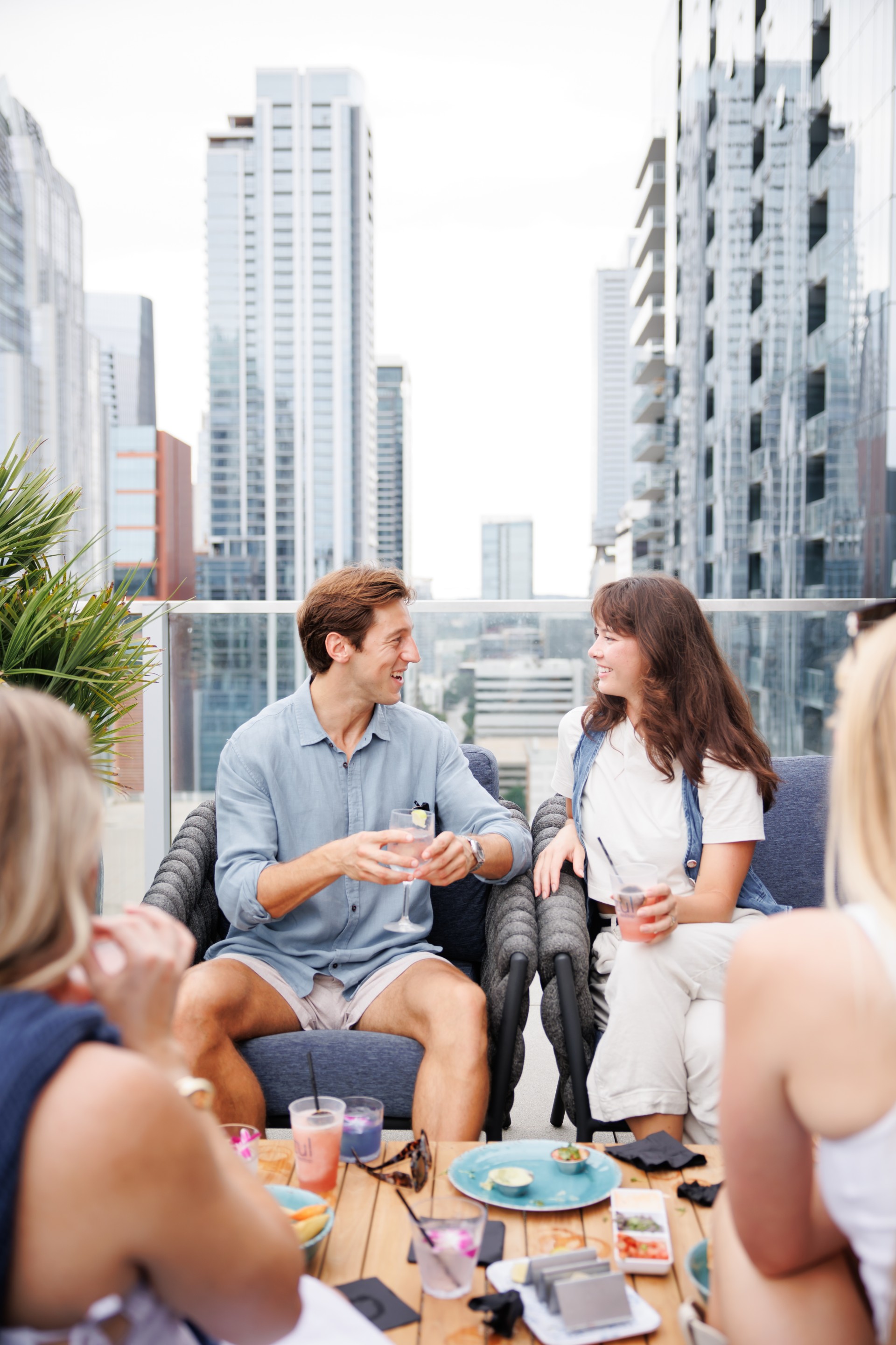 a man and woman sitting on chairs and talking
