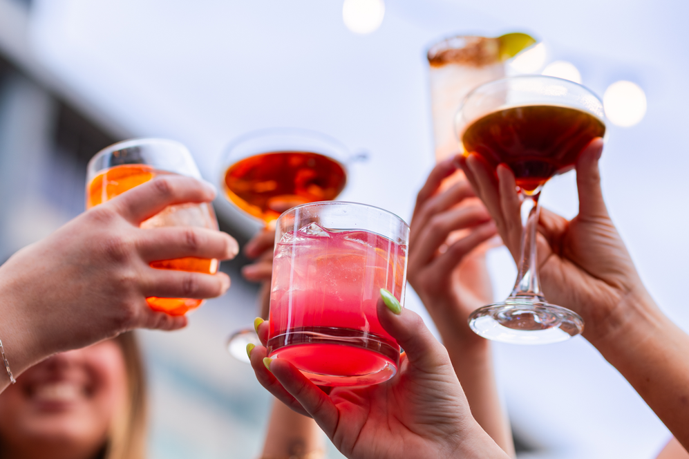 a group of people holding drinks