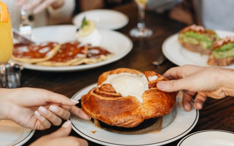 a group of people eating food at a table
