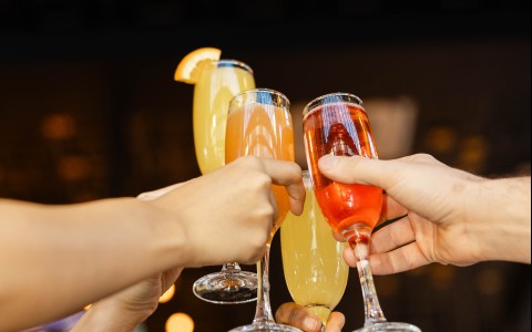 a group of people clinking glasses