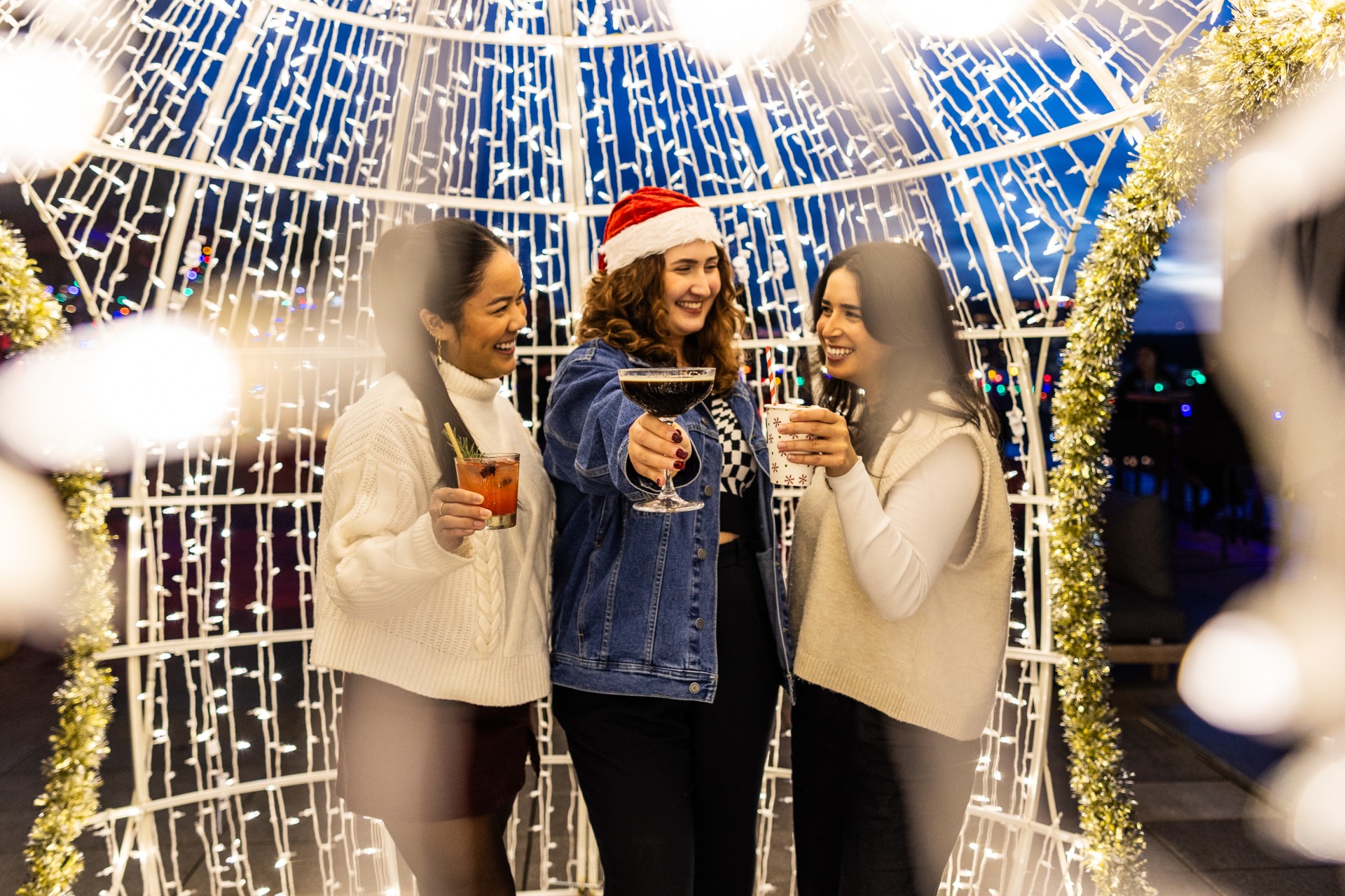 a group of women holding drinks