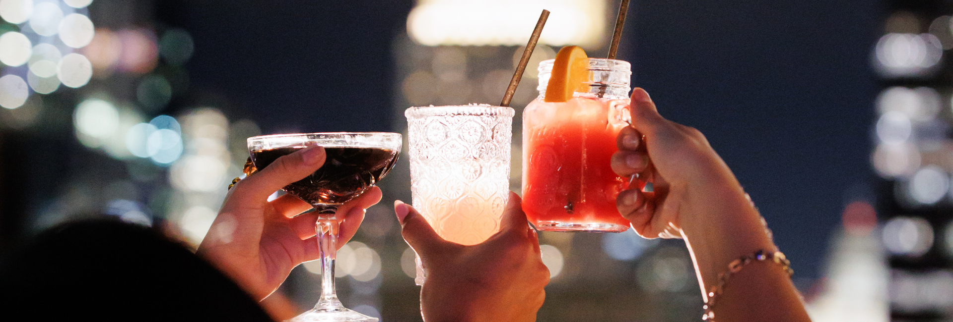 a group of hands holding drinks