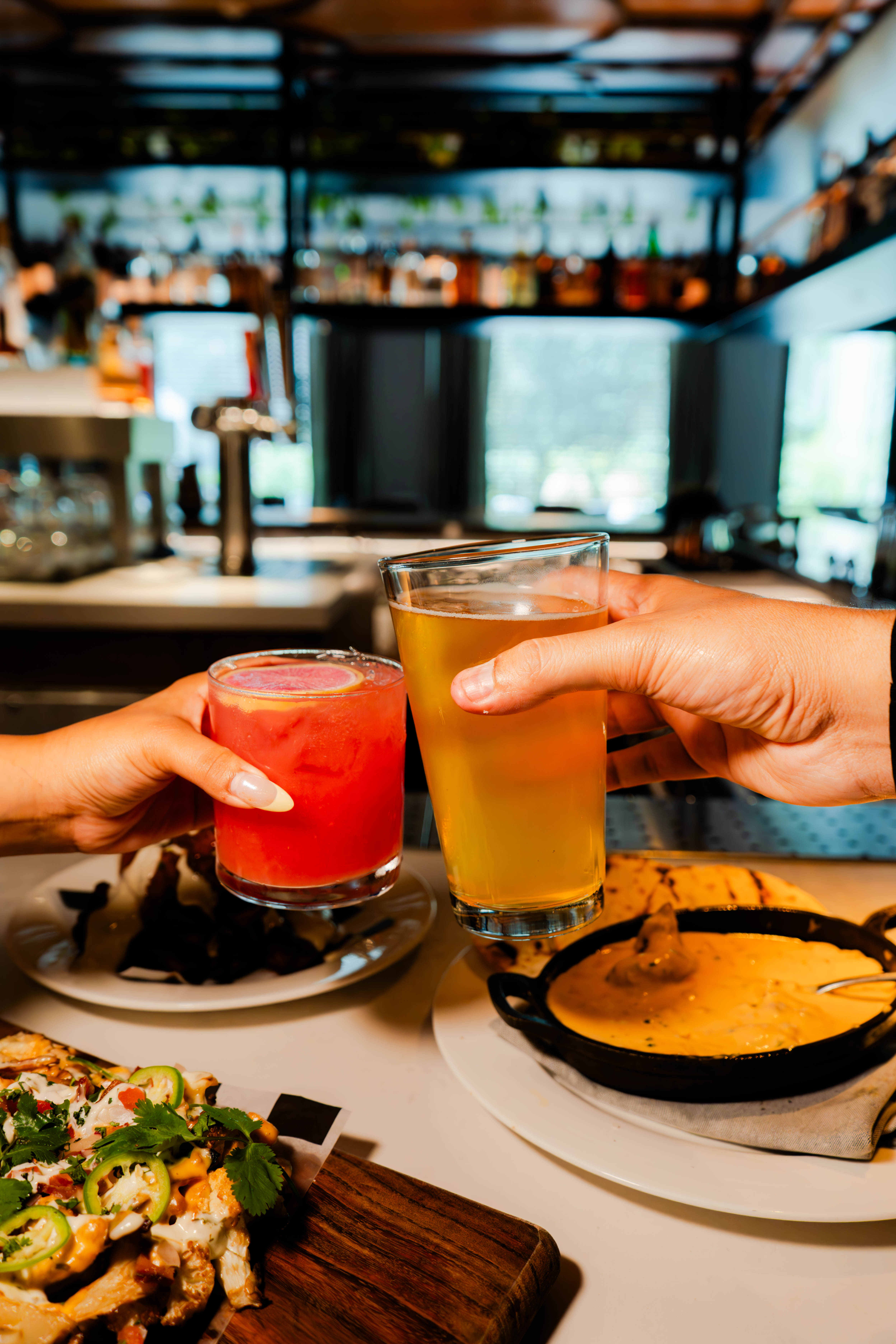 a pair of hands holding drinks