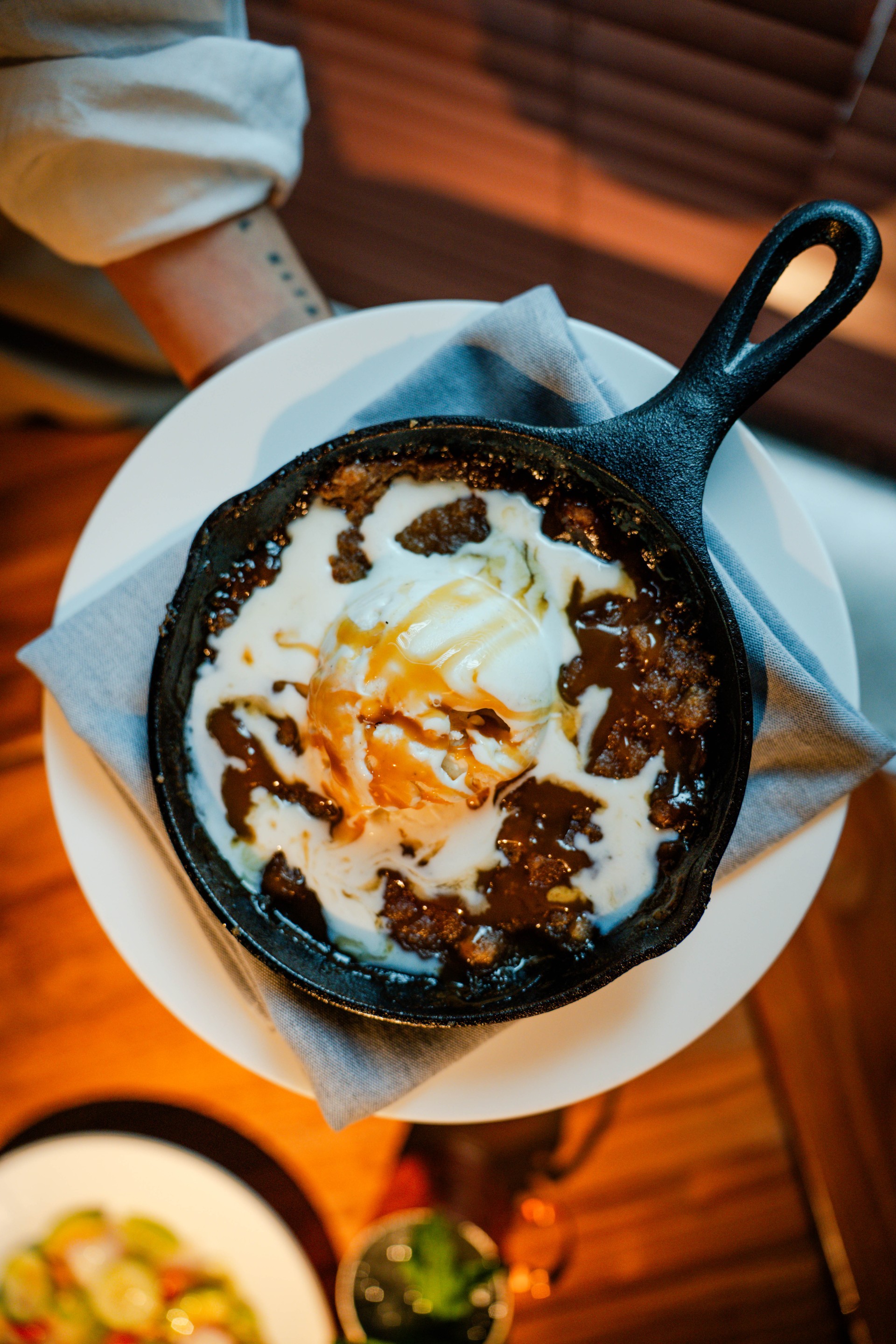 a skillet of food with a scoop of ice cream on top