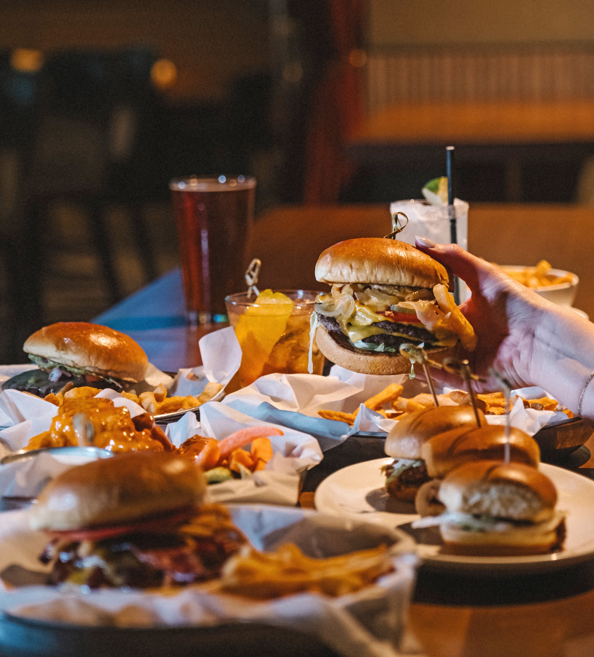 a hand holding a burger