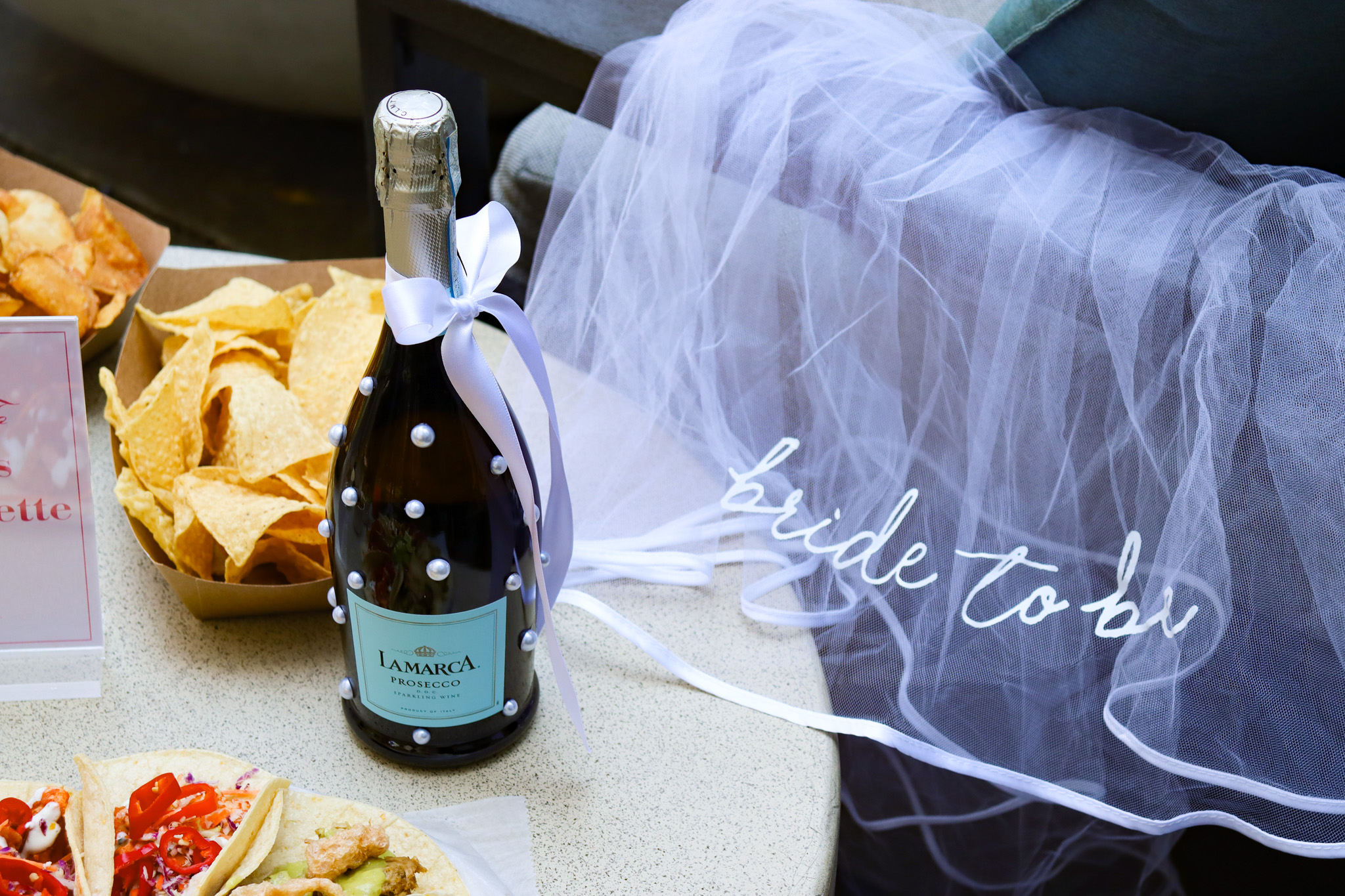 a bottle of champagne and a plate of chips