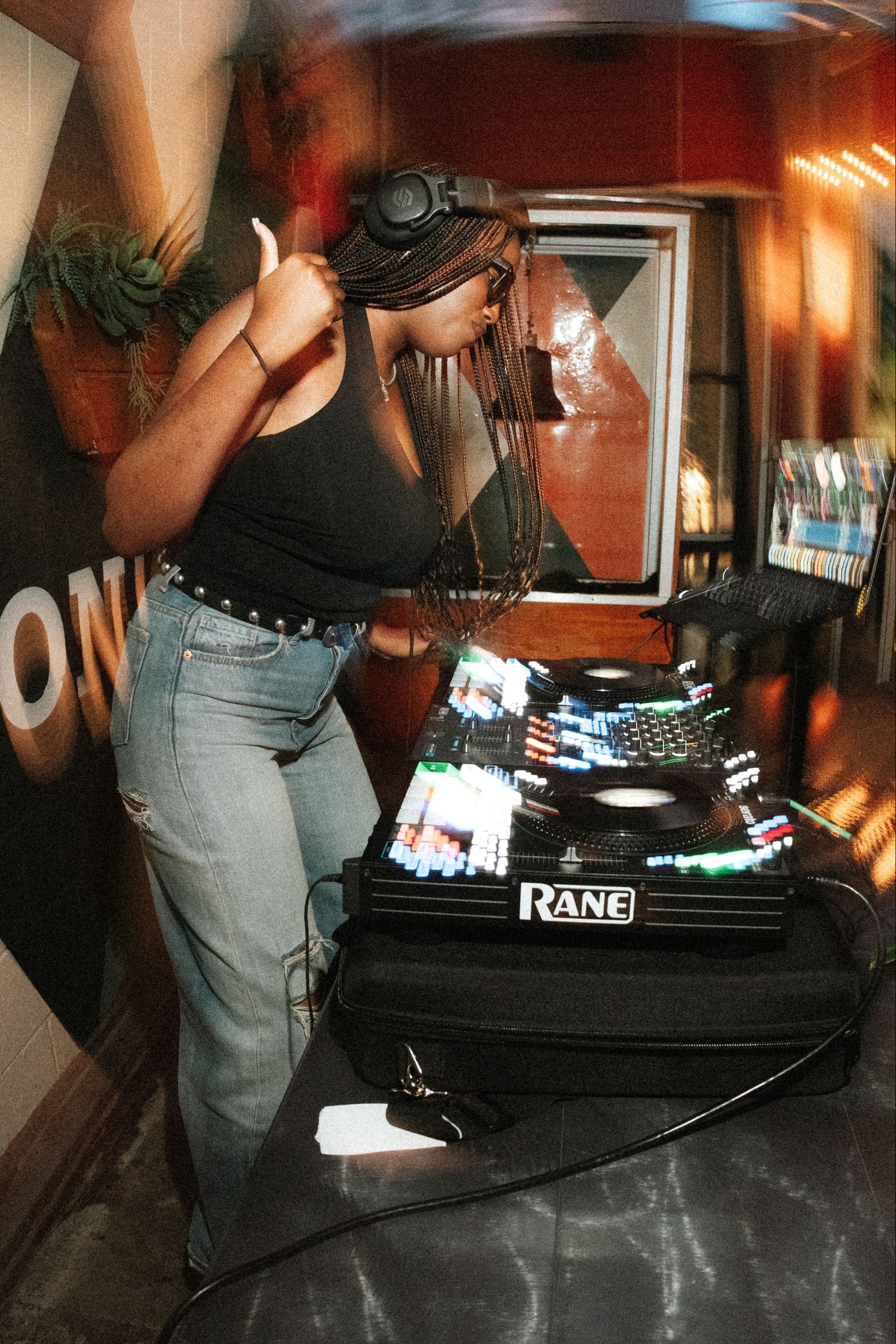 a woman standing next to a turntable