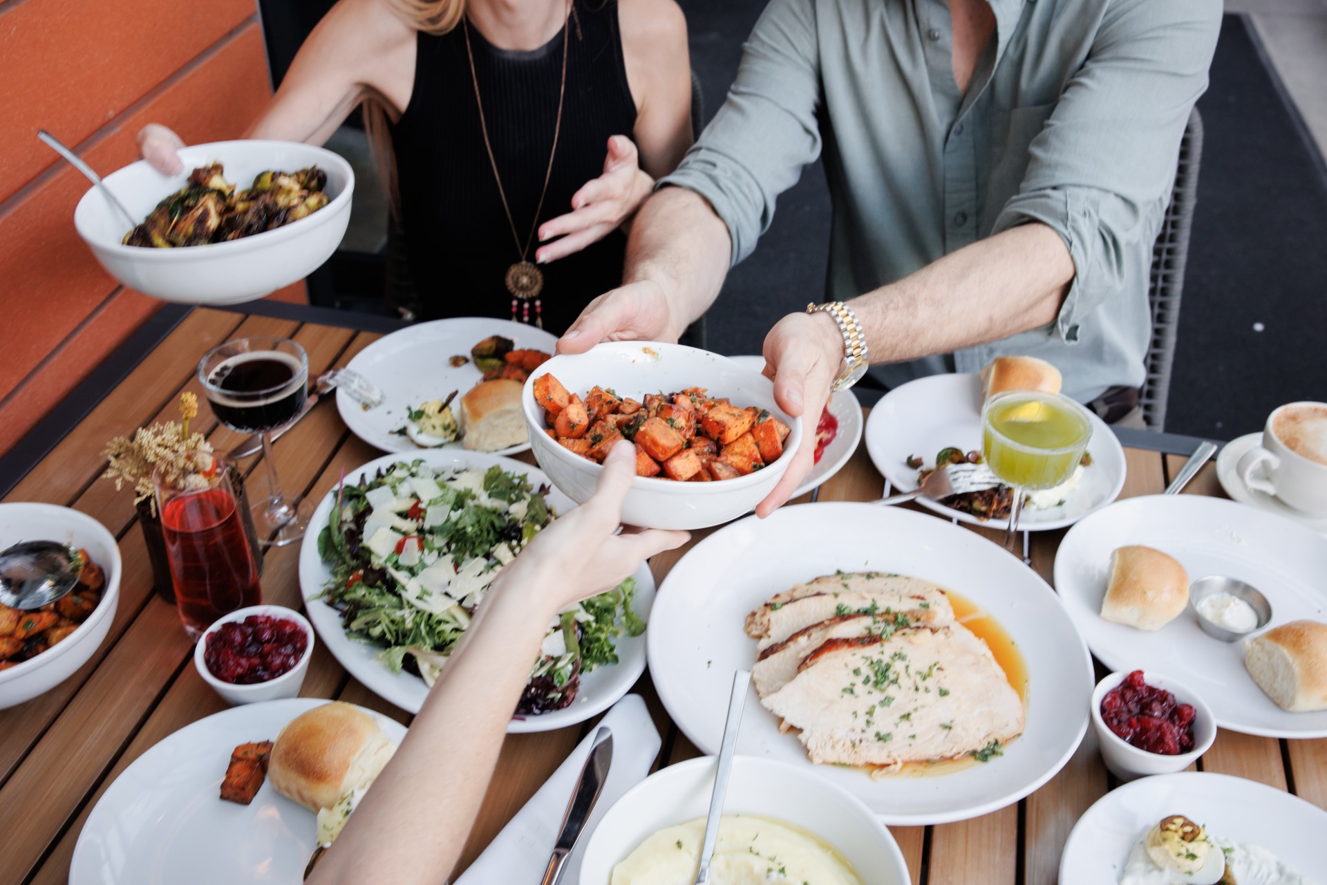 a group of people sitting at a table with food