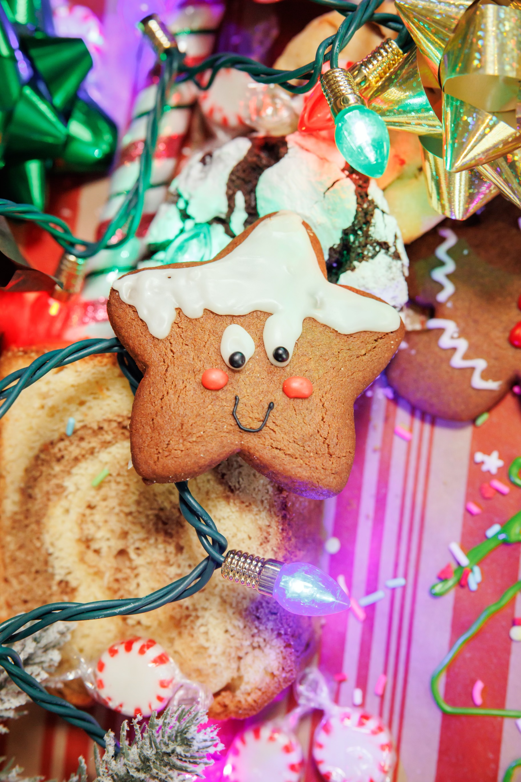 a gingerbread star with a face and a string of lights