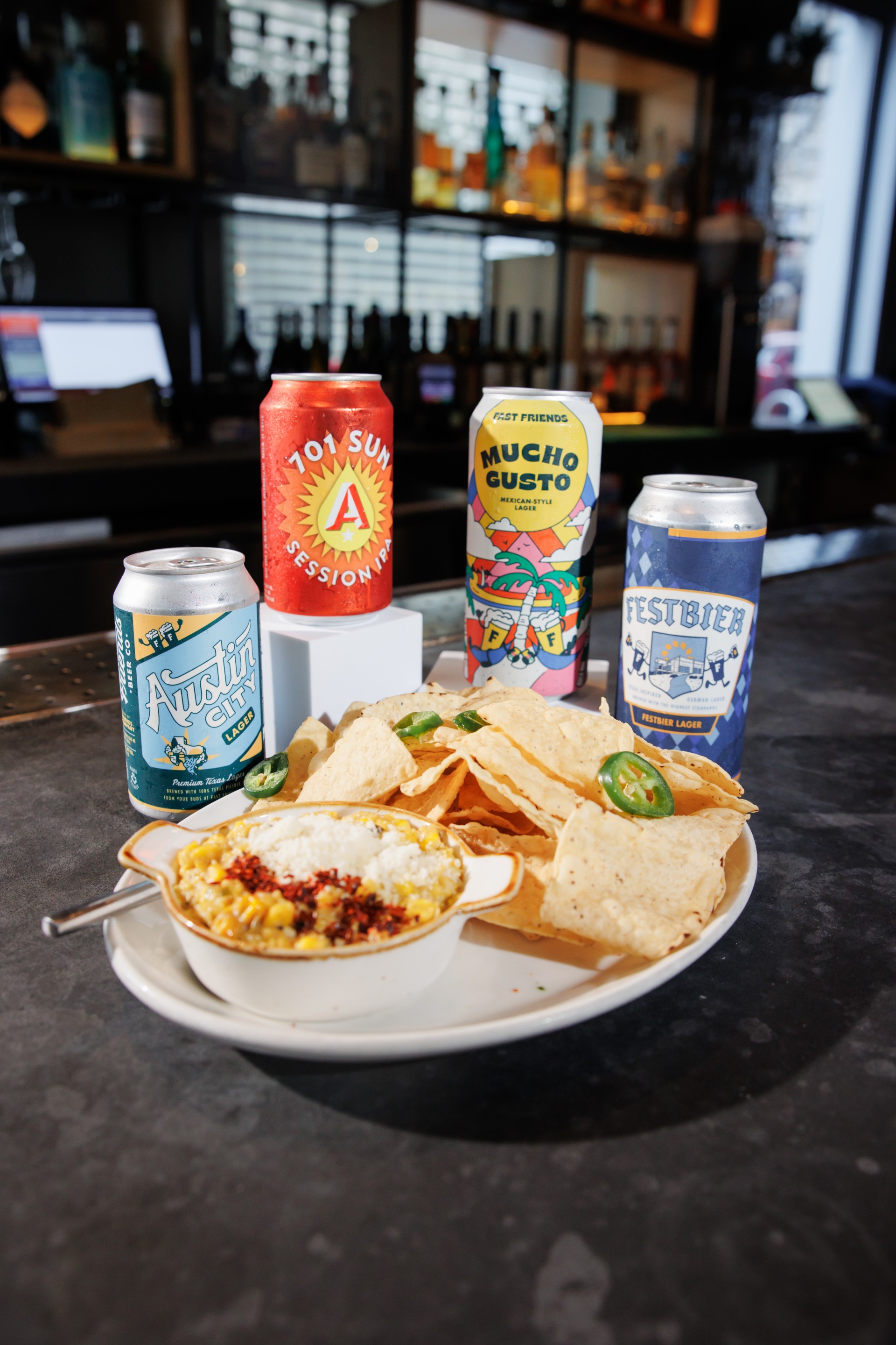 a plate of food and cans of beer