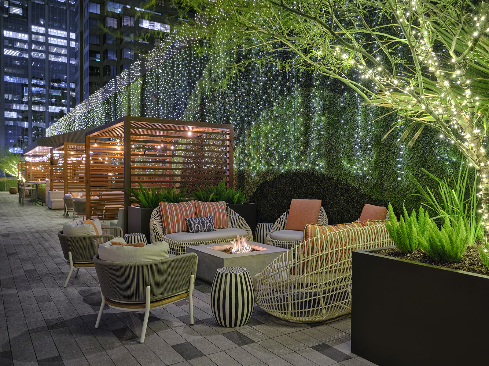 a patio with chairs and a fire pit