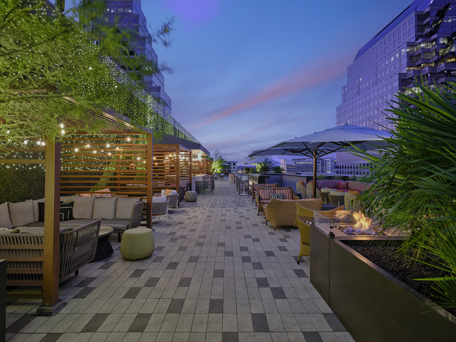 a patio with chairs and umbrellas