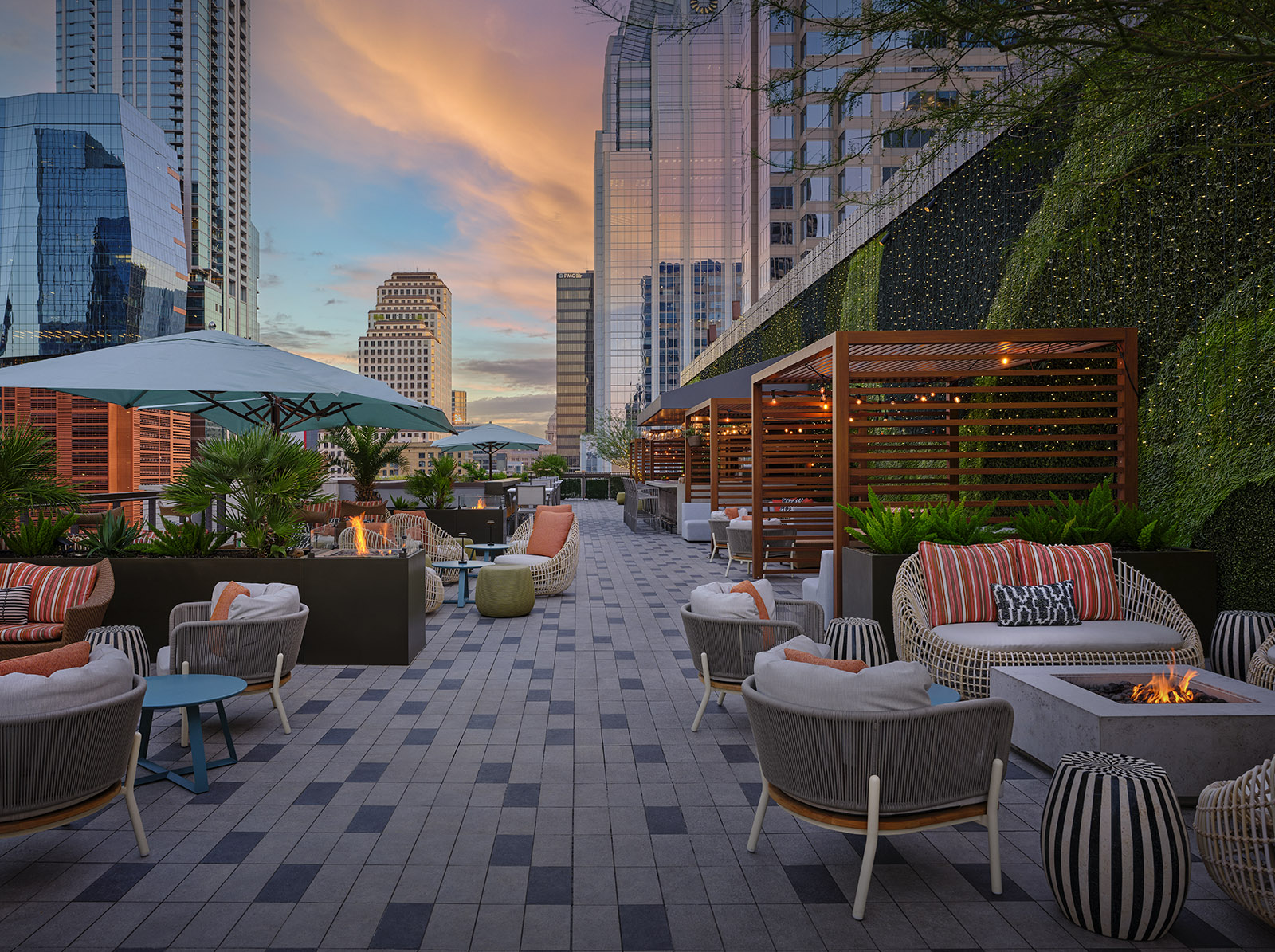 a patio with chairs and tables and umbrellas