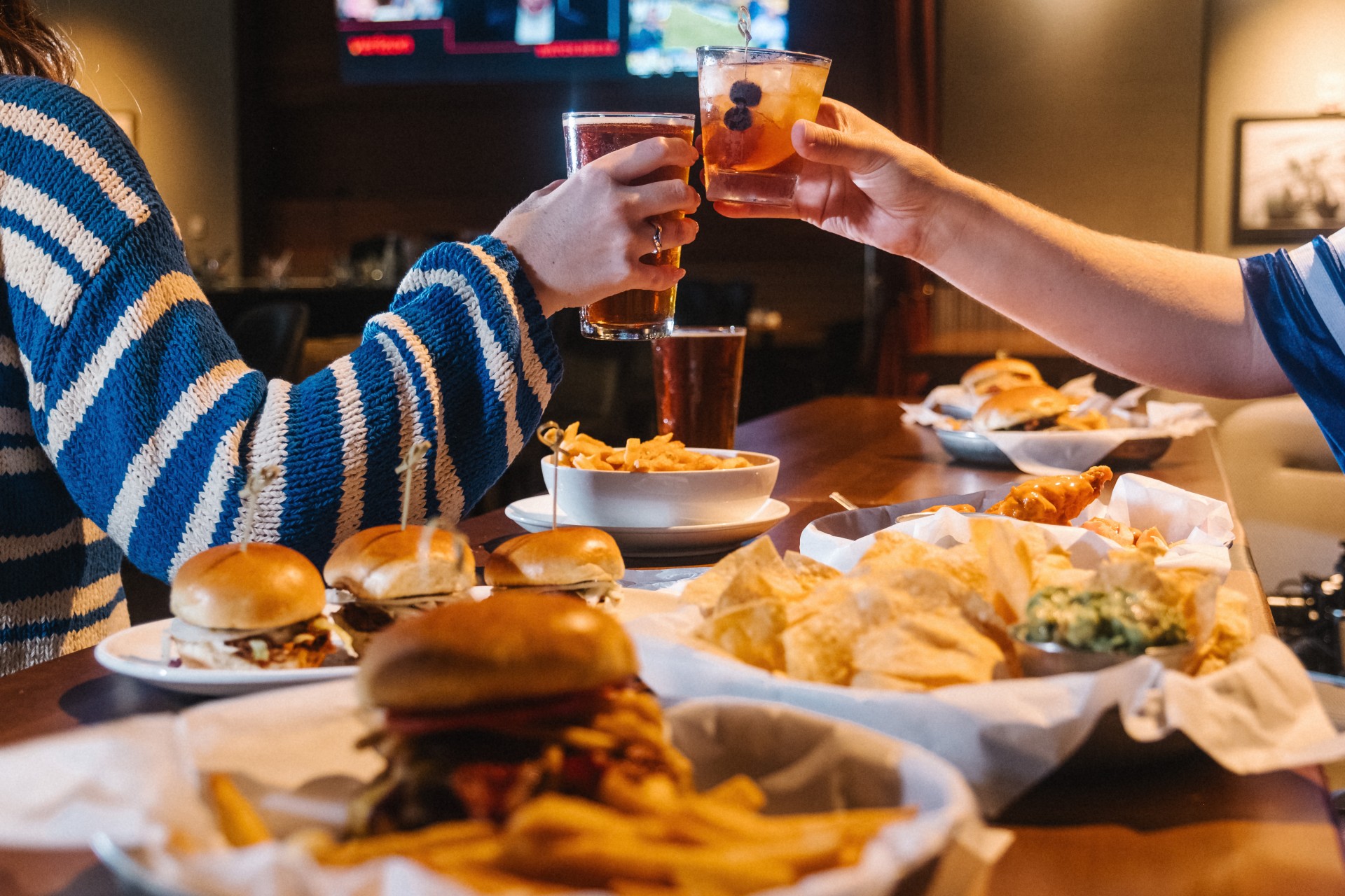 a couple of people sitting at a table with food