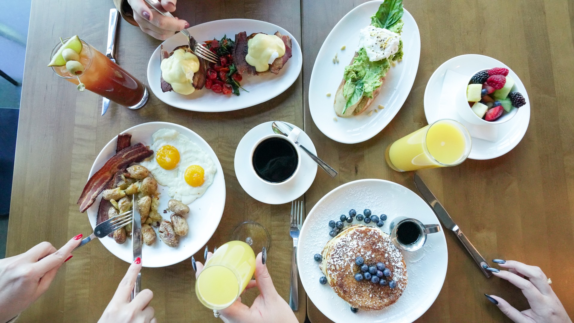 a table with plates of food and drinks